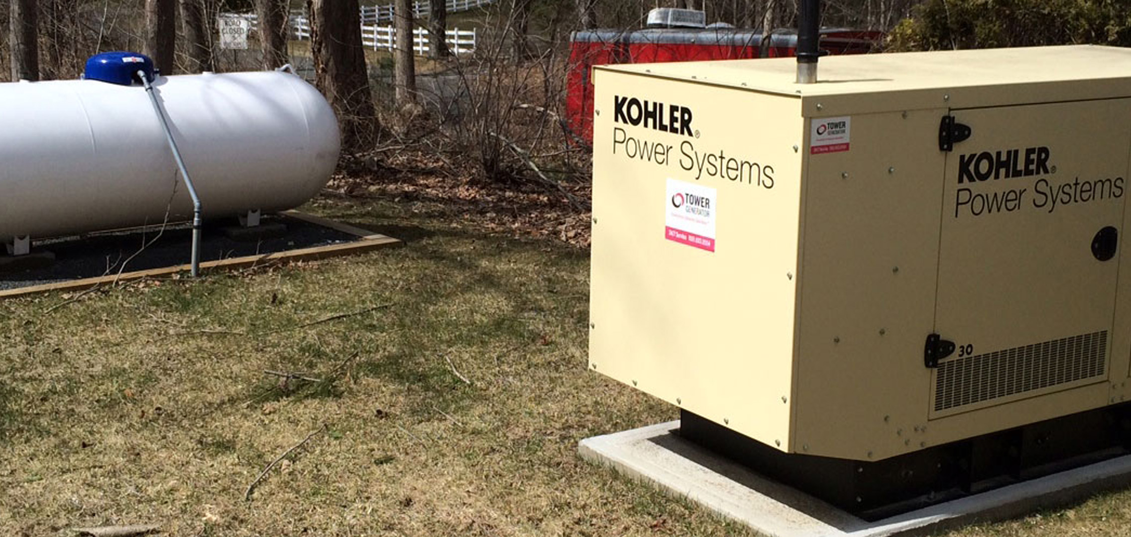 Newly installed commercial generator next to tank