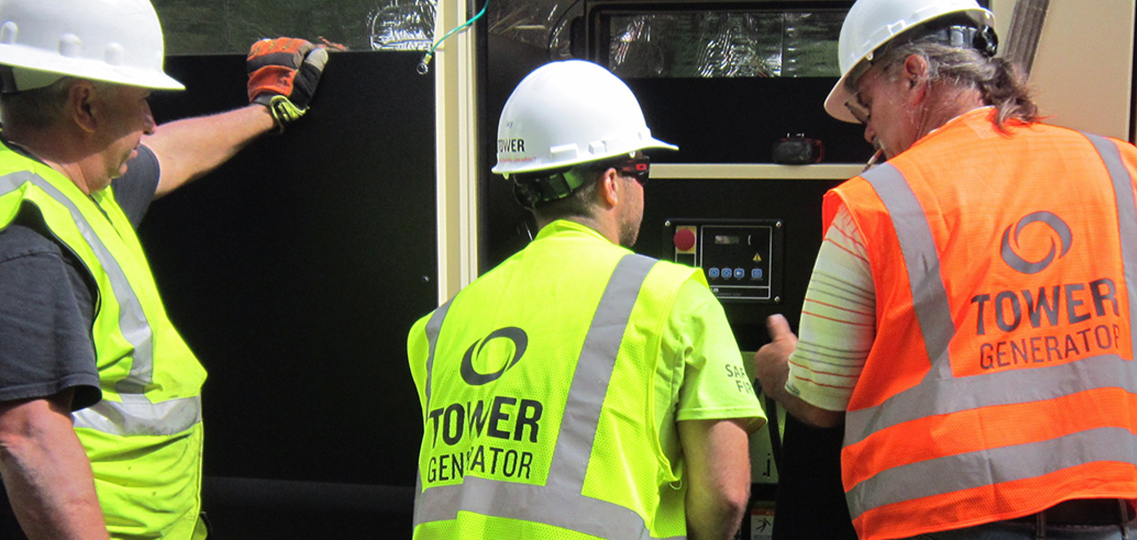 Three Tower Generator employees installing generator