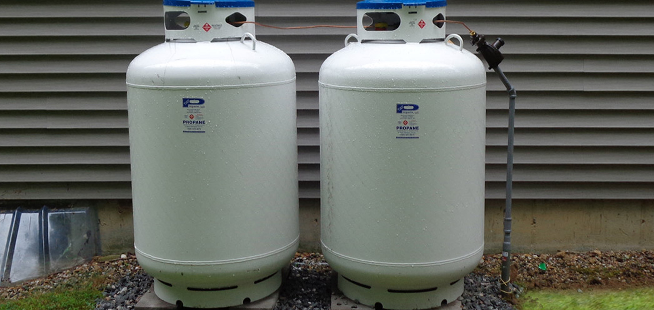 Two propane tanks outside of a house
