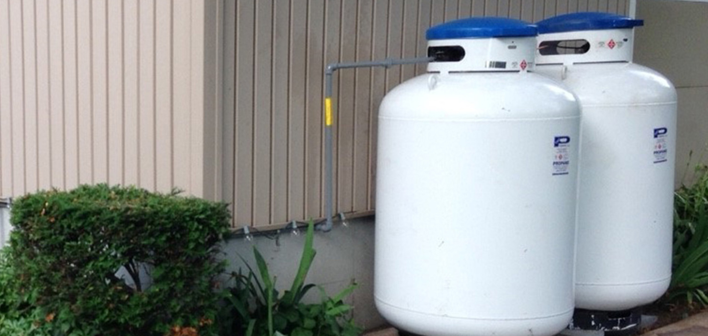 Two propane tanks outside of a house