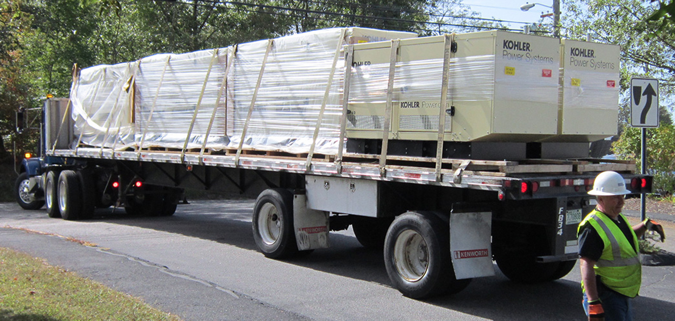Commercial generator being transported on a large truck