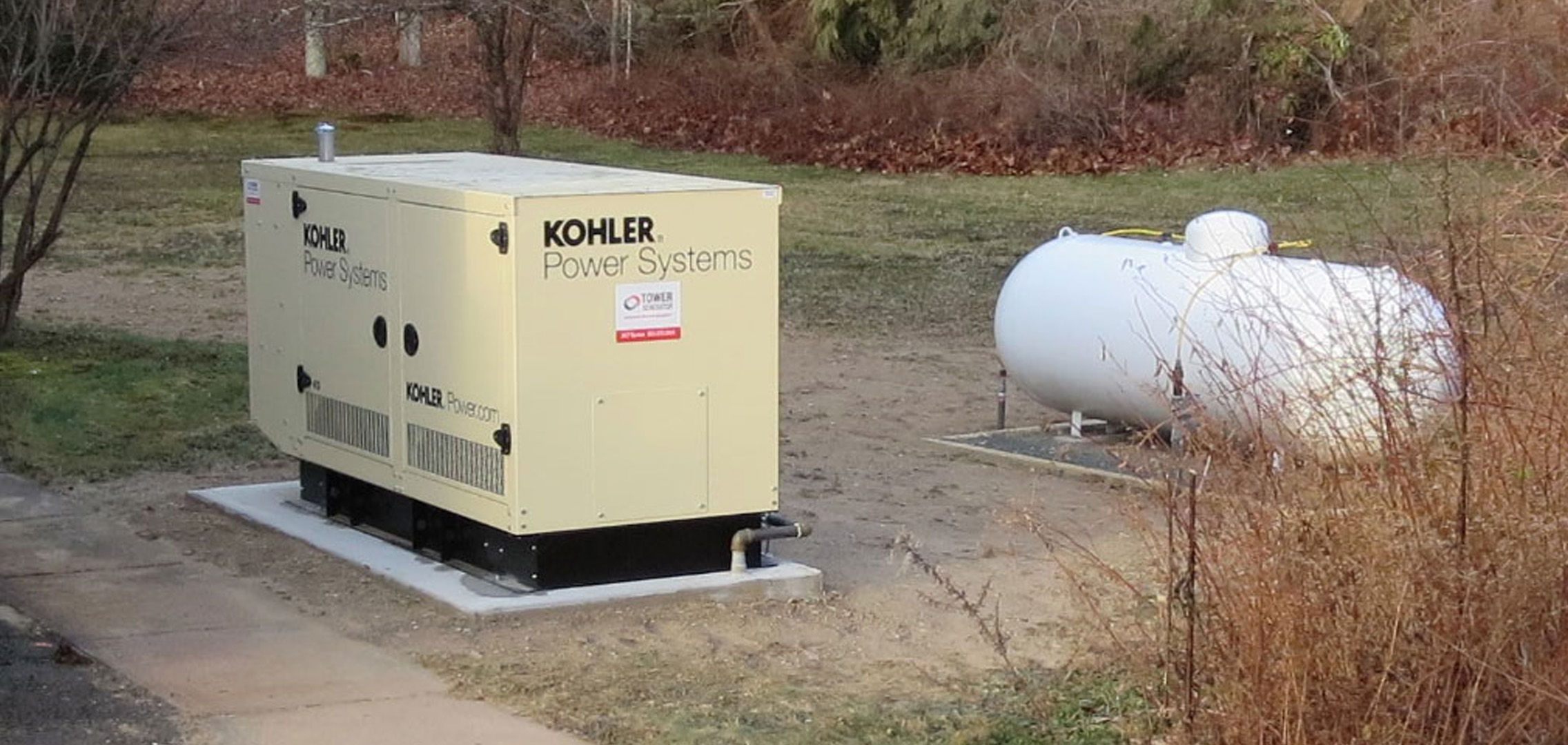 Newly installed commercial generator next to tank