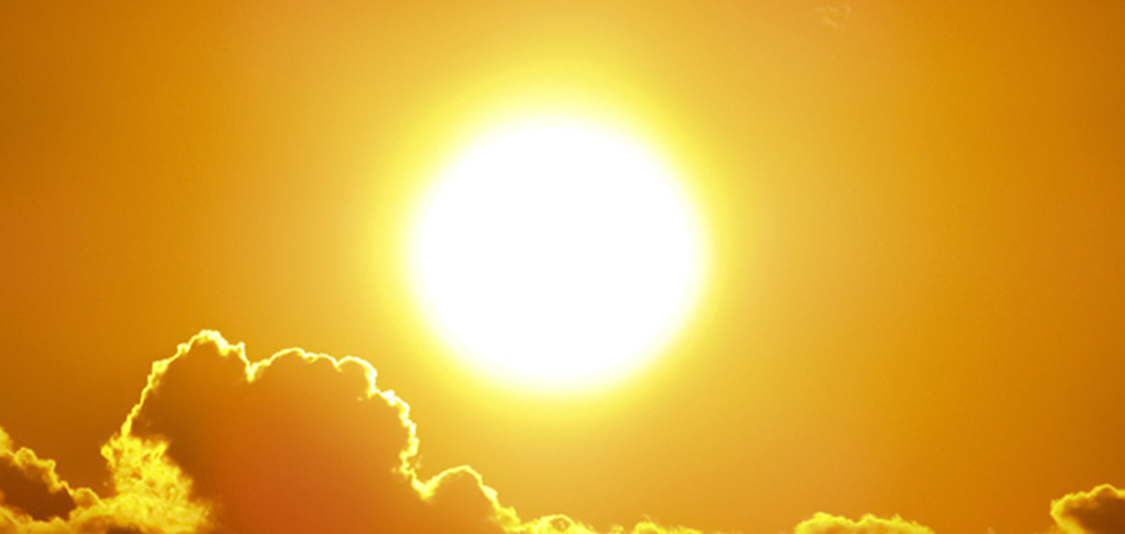 Image of the sun in the sky with some clouds.