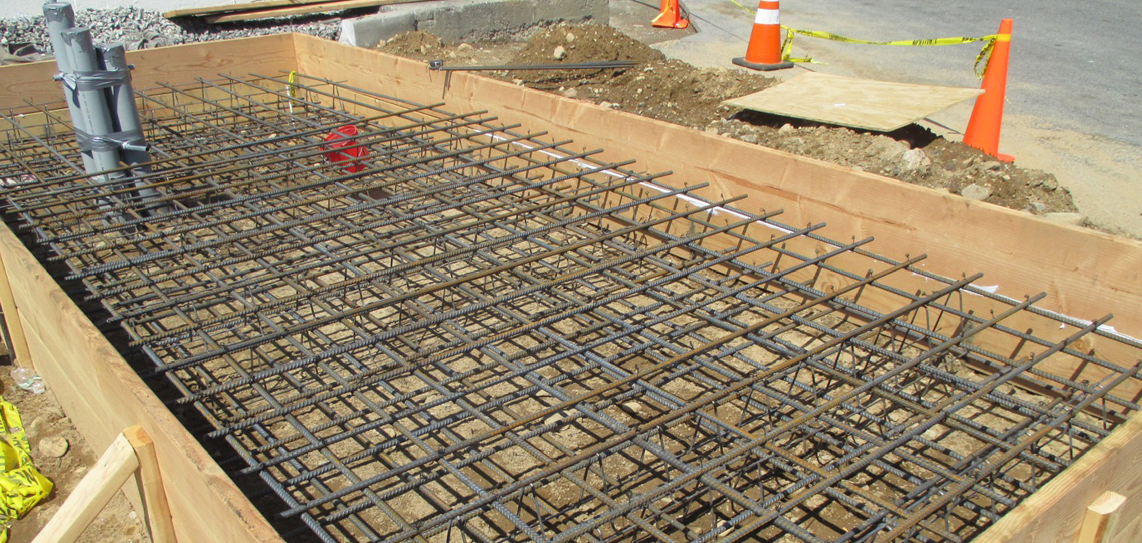 Metal rebar in the base of a large wooden frame