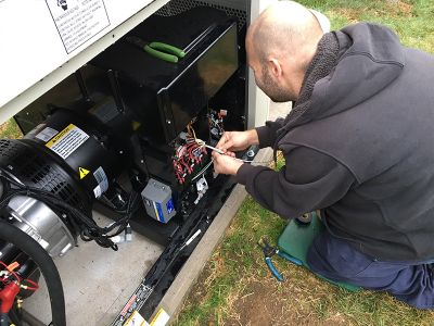 Tower Generator team member wiring and installing a generator 
