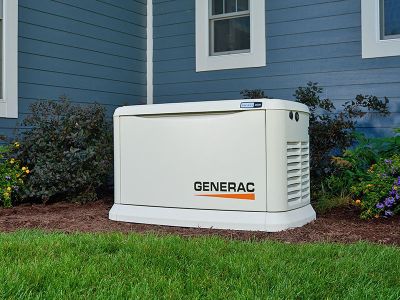 Residential Generac generator outside of a blue house